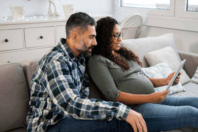 younger couple looking at tablet together
