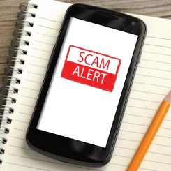 Mobile phone with SCAM ALERT message on screen