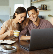Couple at laptop working on their financial goals