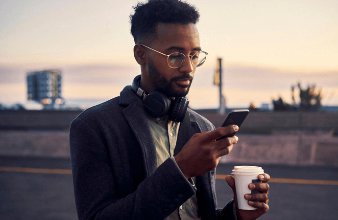 Man with phone and coffee