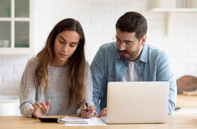 Couple with laptop and paperwork