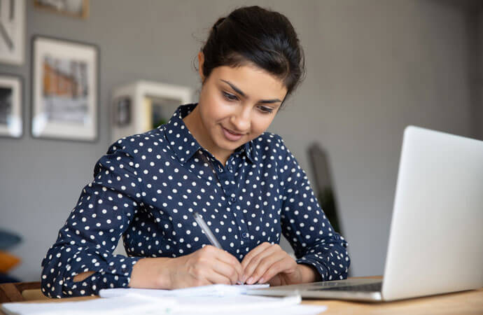 Woman with laptop and paper