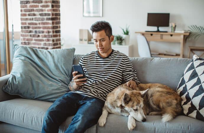 Man with phone and dog