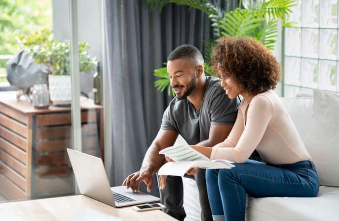 Couple with laptop and paper