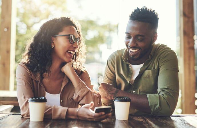 Man and woman with phone and coffee