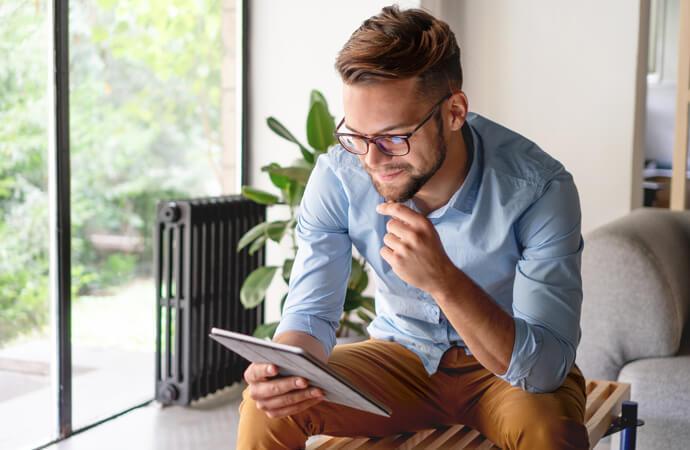 Man sitting reading a tablet
