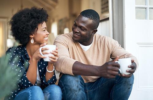 Couple sitting on the porch enjoying coffee