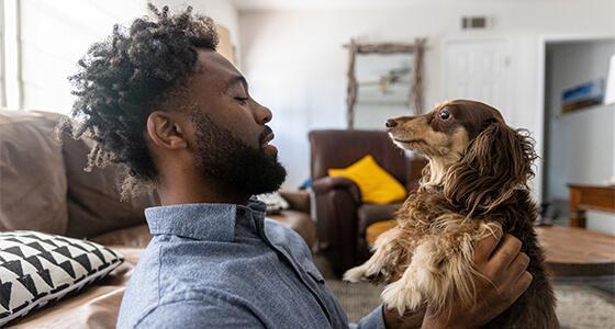 Man holding up his dog