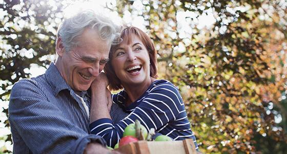 A couple outside enjoying apple picking