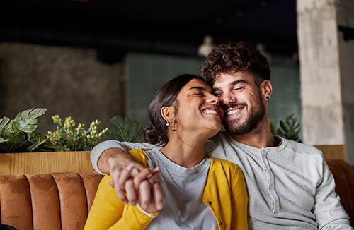 A couple hugging on the couch