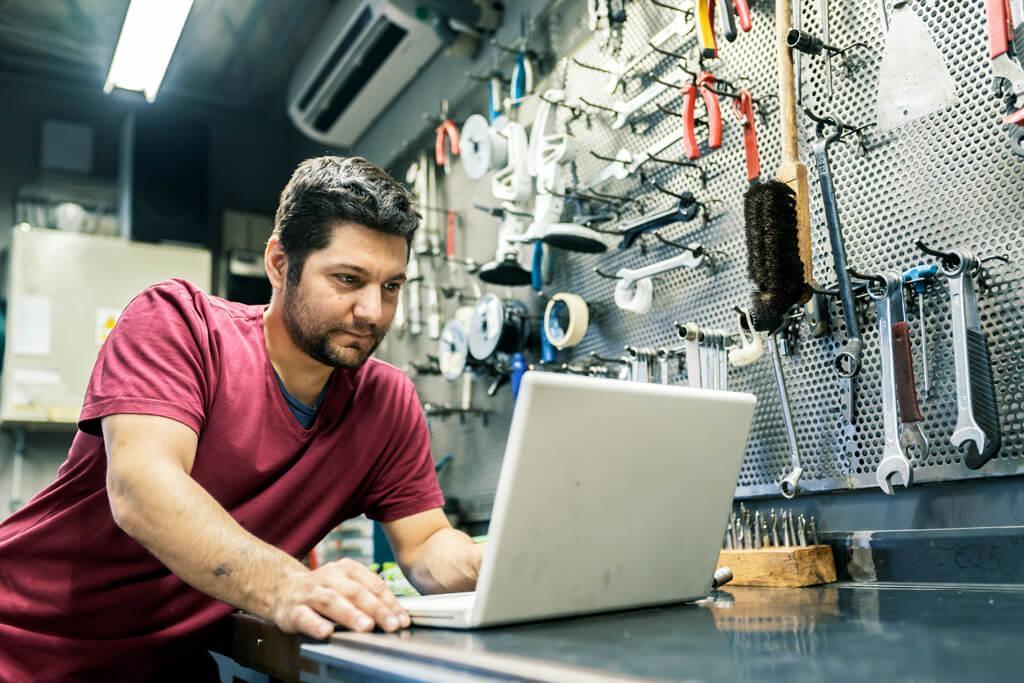 Man on laptop in warehouse