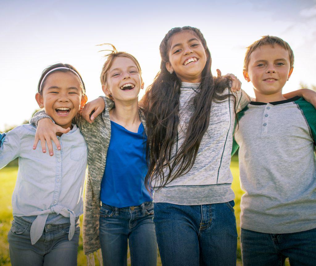 A group of kids, smiling, excited about their financial future.
