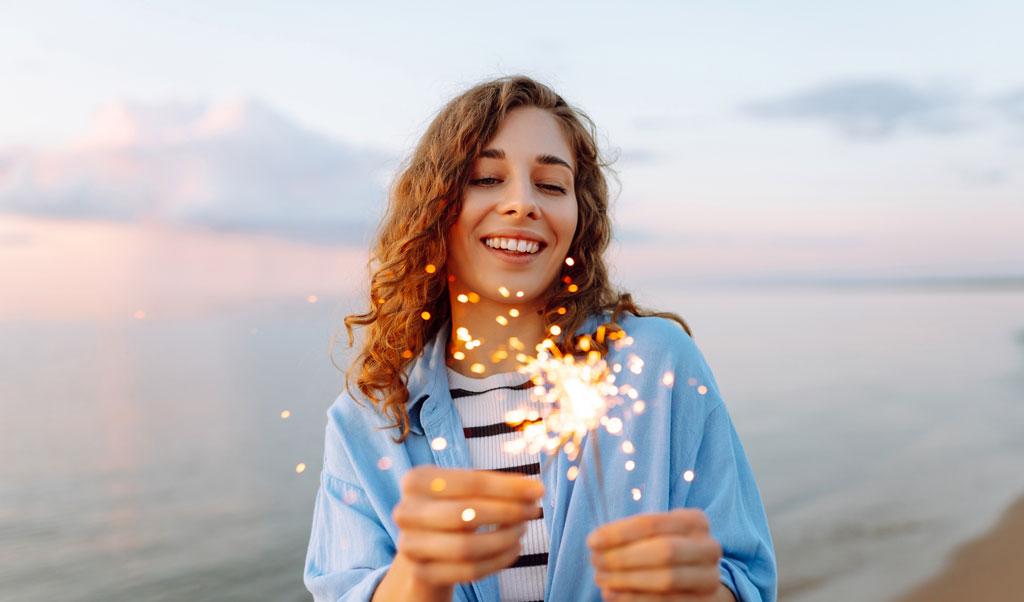 Happy woman with string lights