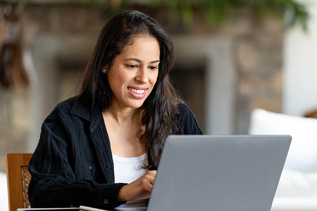 Woman using computer at home in a beautiful house